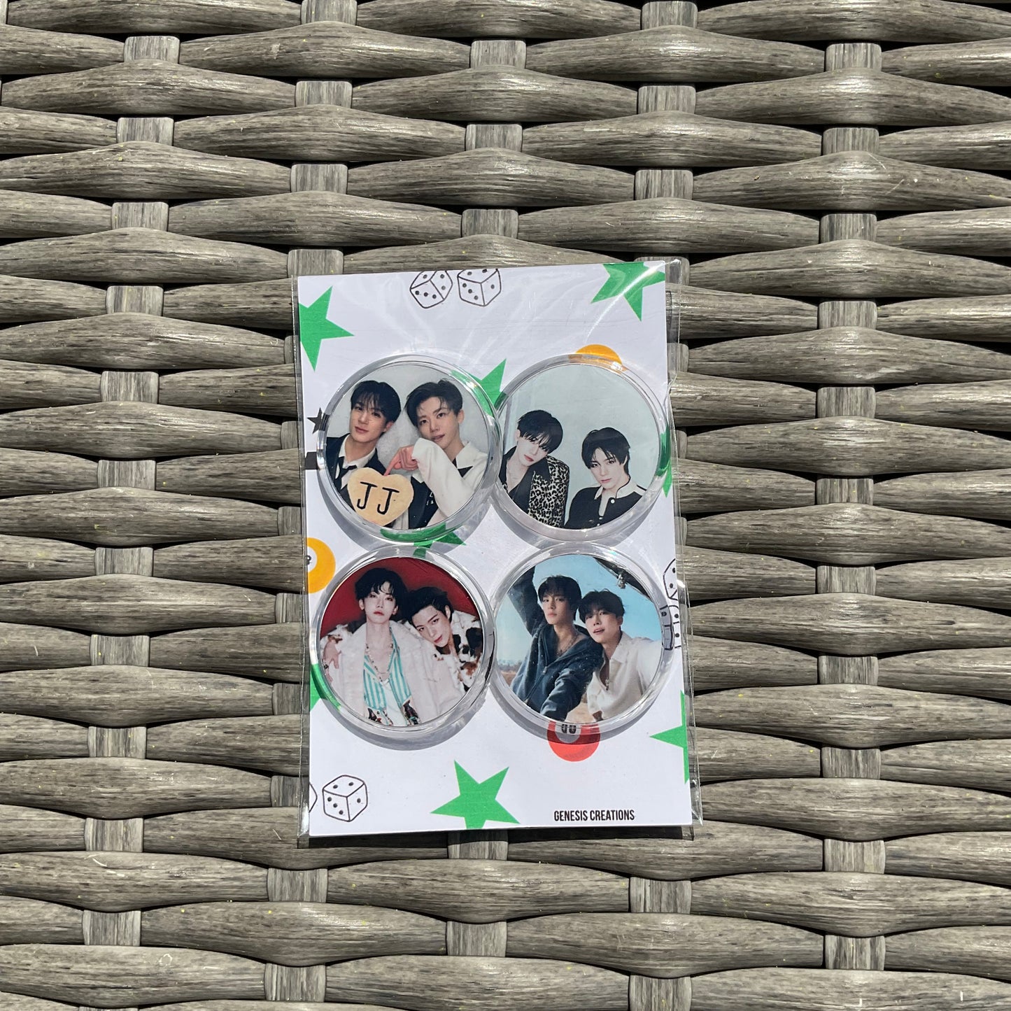 Set of four round stickers with images on a white card with green star designs, placed on a woven surface.