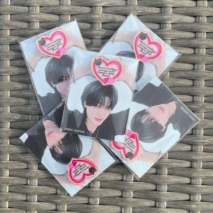 Five cards featuring a person with a heart design on a woven surface