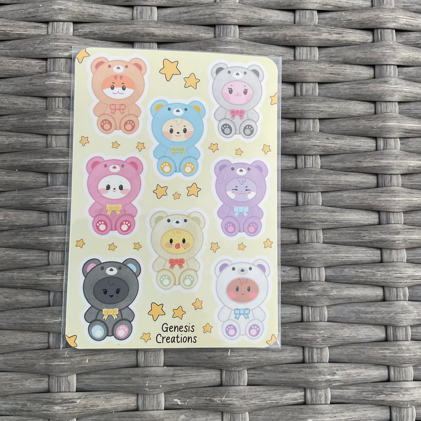 Sheet of colorful bear stickers on a woven surface