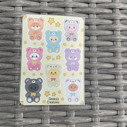 Sheet of colorful bear stickers on a woven surface